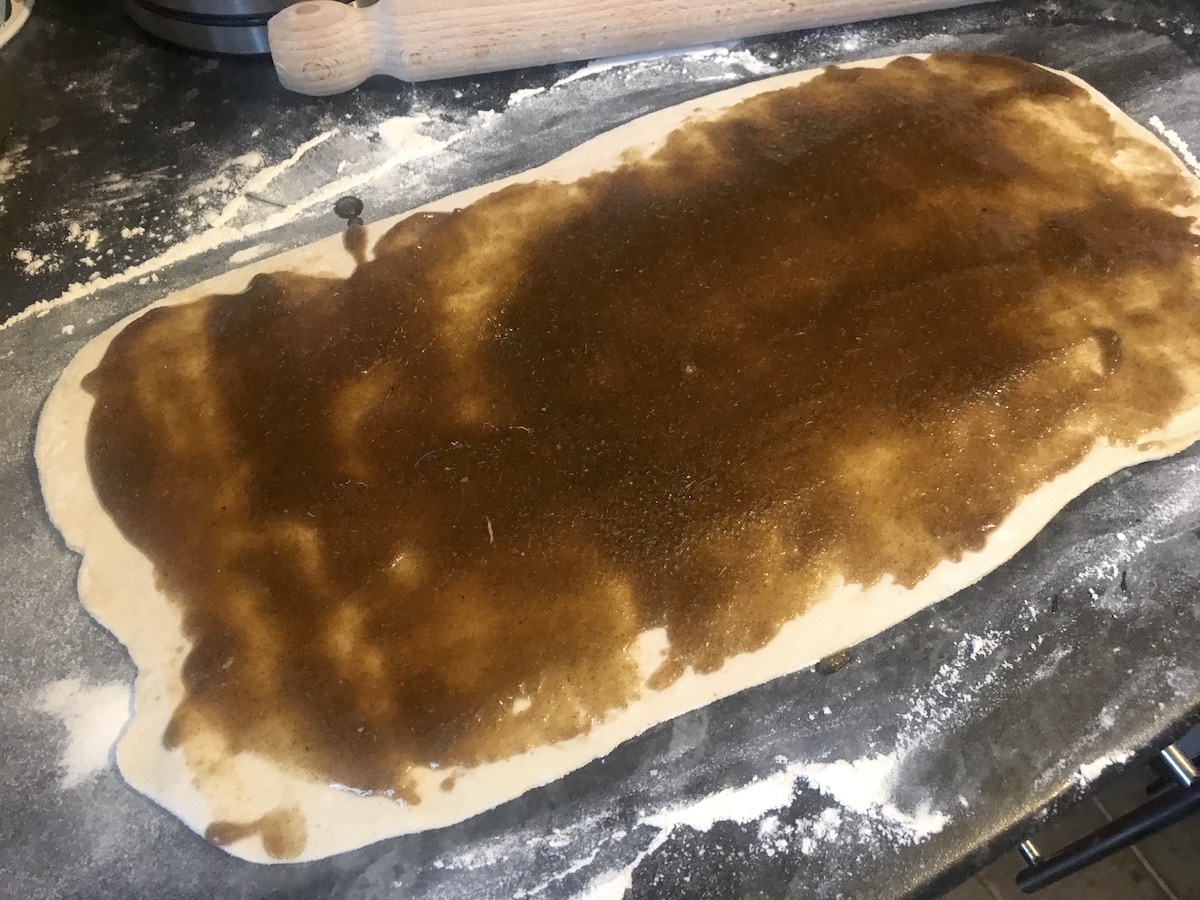 spreading cardamom butter onto buns