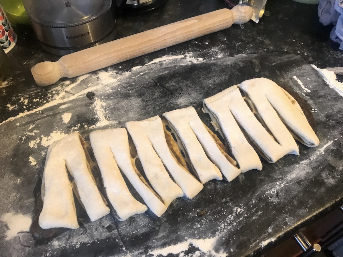 cutting cardamom bun pastry